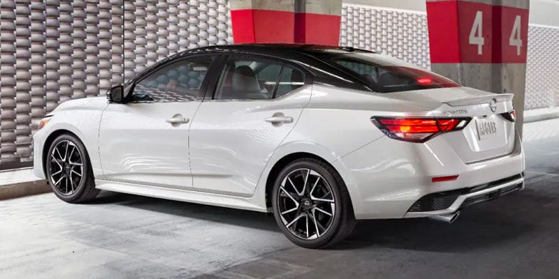 A Chevrolet Malibu sedan driving along a coastal highway
