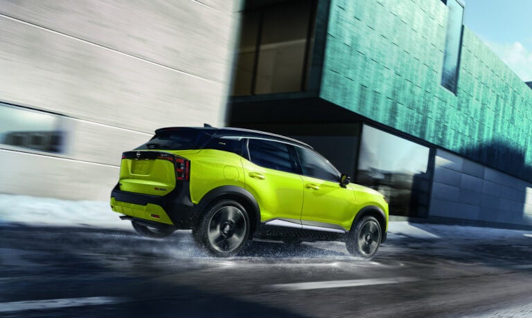 2026 Nissan Kicks driving fast in the snow